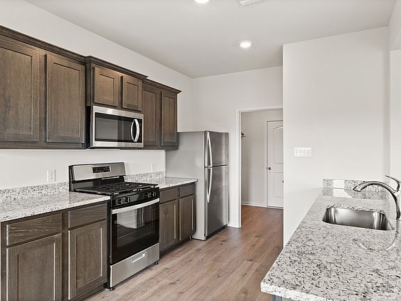 The kitchen has beautiful wood cabinetry.
