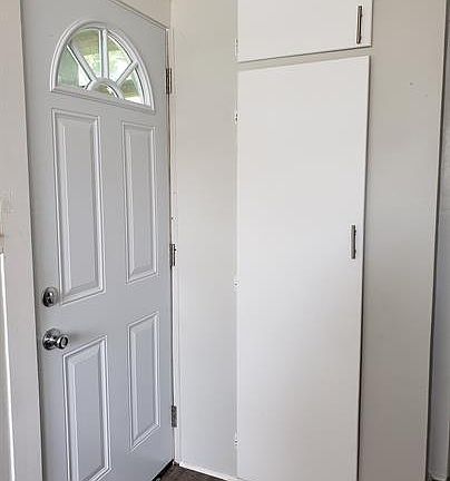 back door in kitchen with a closet