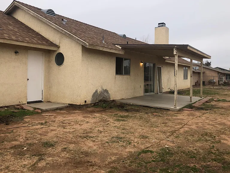 Patio cover with slider door & door leading into Garage