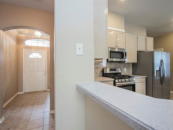 View of foyer from den/kitchen area.