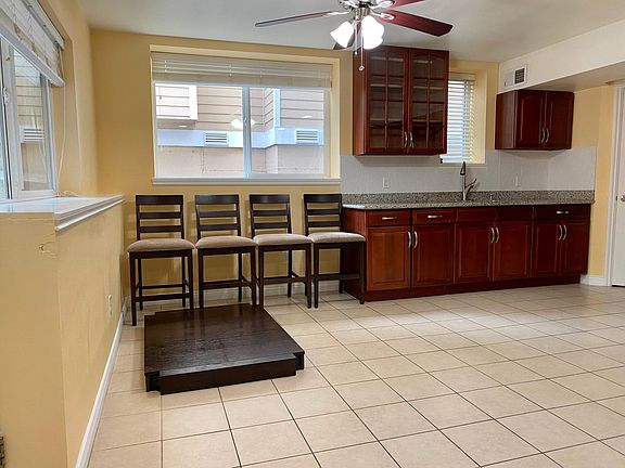 Kitchen with tile floor and sun filled
