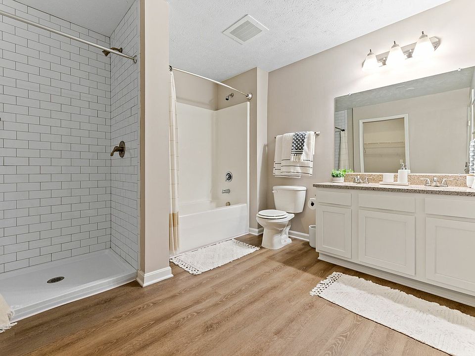 Relax in a spa-inspired bathroom with double vanity and walk-in shower for a luxurious living experience in Akron