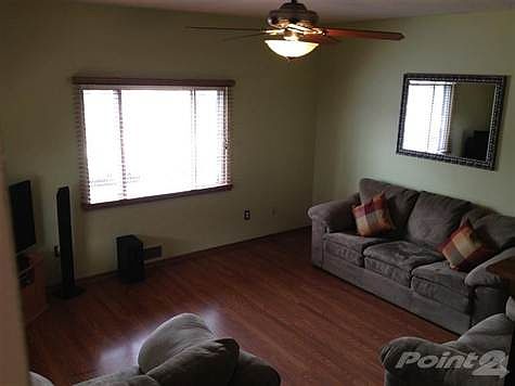 Great Room with Easy Care Laminate Wood Flooring, Custom Faux Wood Blinds and Updated Lighting Fixtu