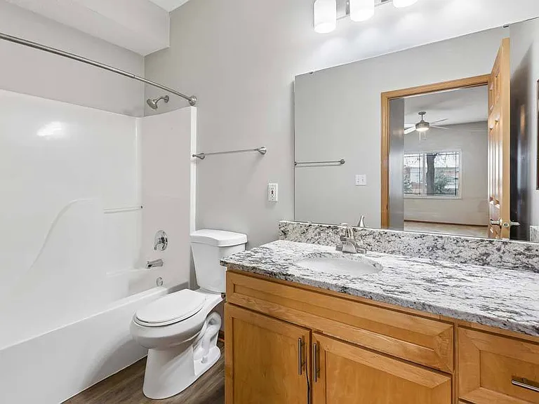 A fresh, polished bathroom featuring sleek counters and plenty of space to refresh and recharge.