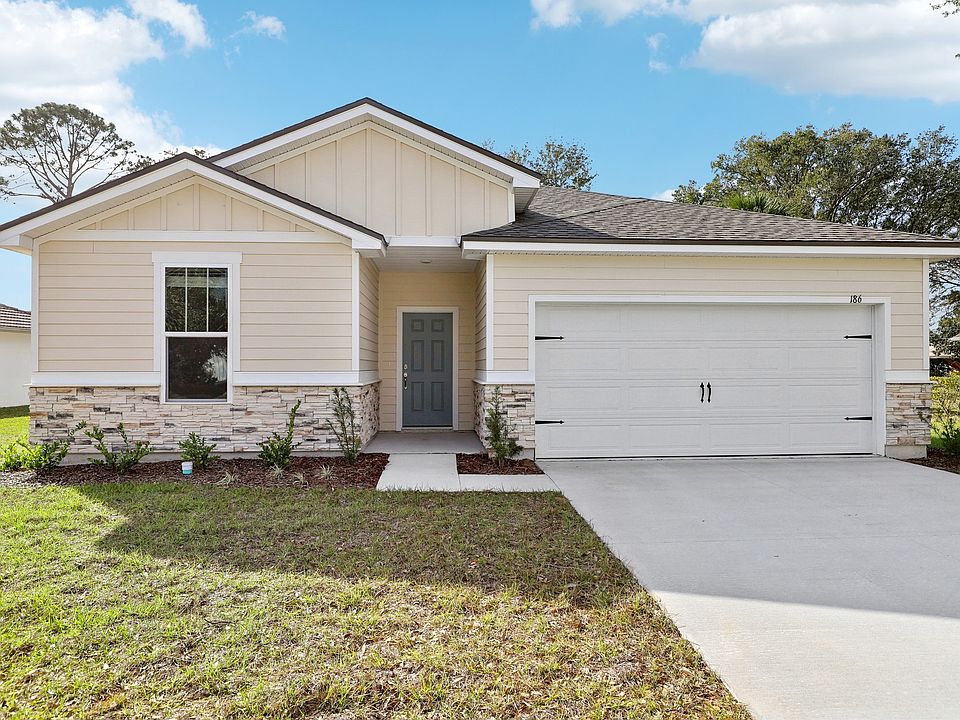 Elegant single-story design with stone facade, gabled roof. Designed for modern luxury in Palm Coast