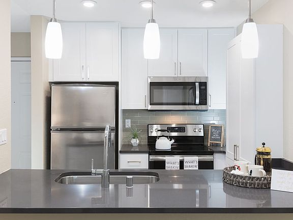 Modern Collection Kitchen With Quartz Countertops Ceramic Tile Backsplash And Stainless Appliances