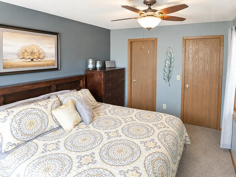 Primary bedroom. Doors to private bathroom and closet.