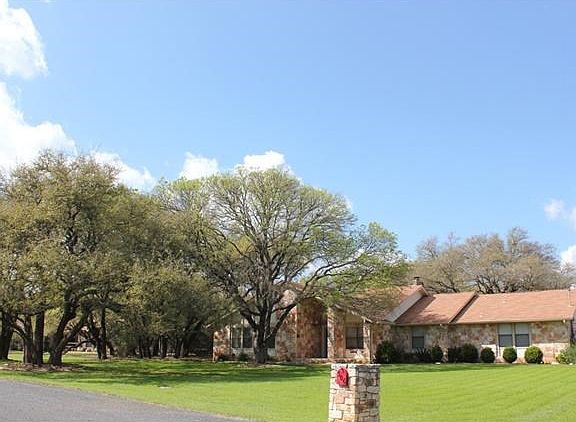 In ground sprinkler system keeps this lawn looking lush, and the native trees and attractive landscaping make this one of the nicest home in the neighborhood.