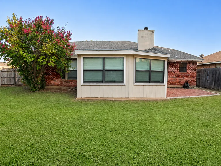 Spacious backyard with green grass. Enjoy fresh air and quiet time outdoors.