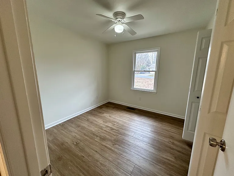 Final photo of Bedroom #4 with a large closet and view of the front yard, This is the first bedroom as you walk down the hallway.