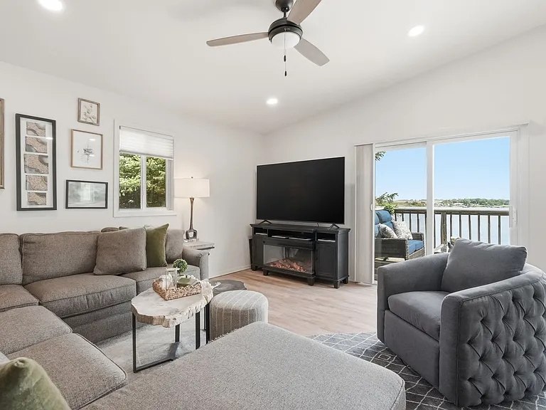 Lake view from the upper level family room w/ TV & electric fireplace.