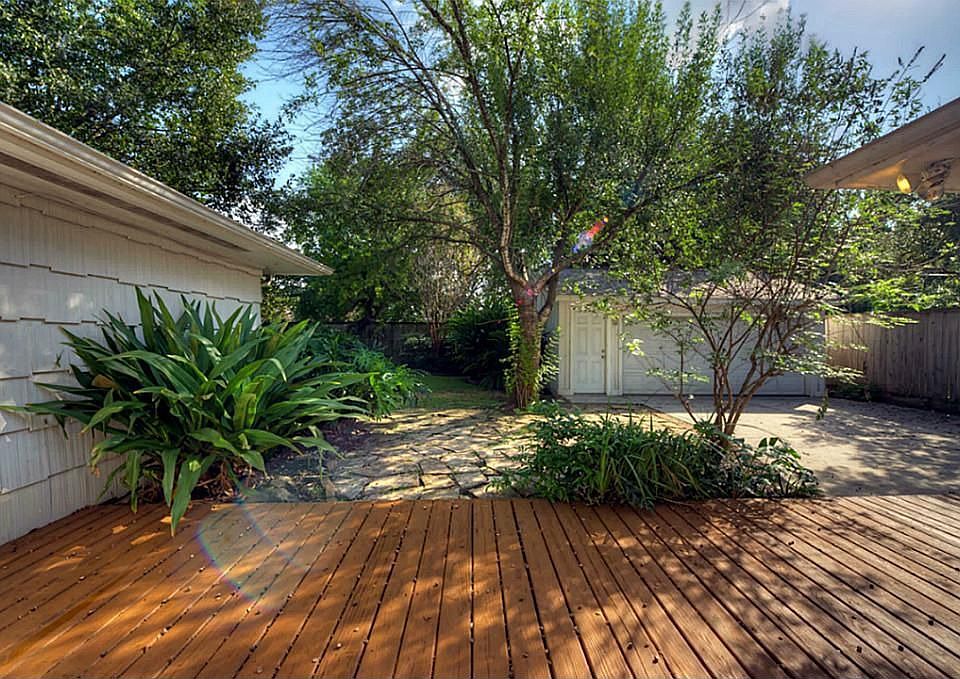 Beautiful back yard with porch and plenty of shade.