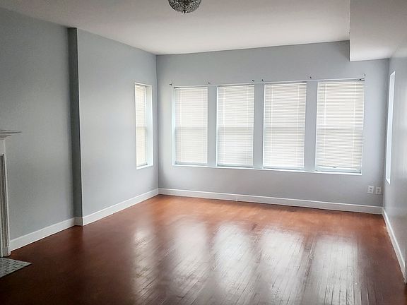 Large living room with decorative fireplace ready for a new insert!