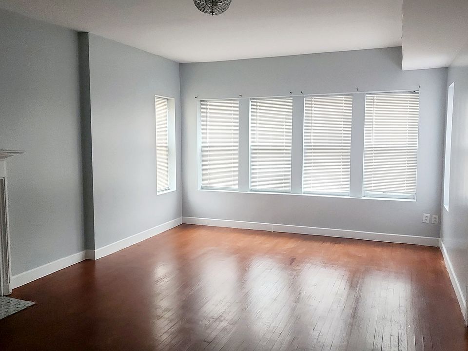 Large living room with decorative fireplace ready for a new insert!