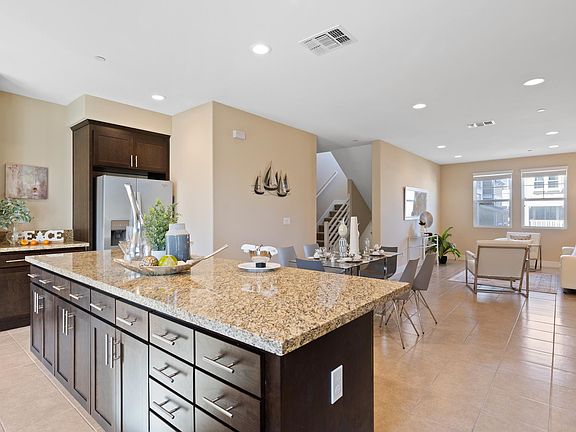 Granite top island with plentiful storage areas.