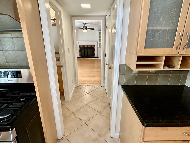View from the kitchen just past the half bath and two full pantries on the right looking into the living room.