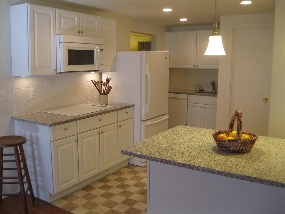kitchen bathroom door to right of the hanging lamp
