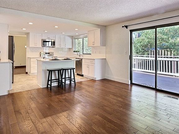 Another view of the open kitchen and family room, with slider out onto entertainment sized deck and private backyard.