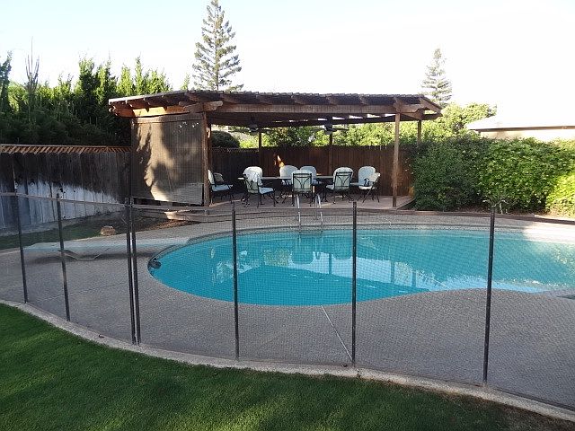 Backyard pool with Fence and Covered Deck