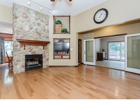 Great Room with See Through Fireplace, Wood Flooring and 12 Foot Ceilings