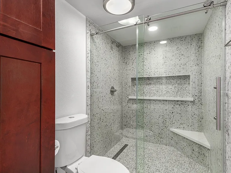 Granite shower with sliding barn door glass