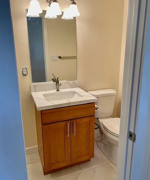 Recently updated bathroom with quartz countertop and tile flooring