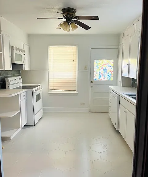 Kitchen - new floors, freshly painted cabinets.