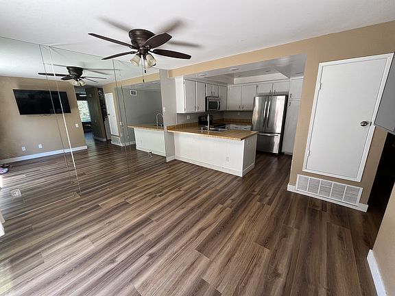 Dining room and Kitchen with full wall mirror and tv mount.