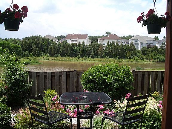 Stone Patio with English Garden, Sprinkler System and Fenced yard leads to Lak