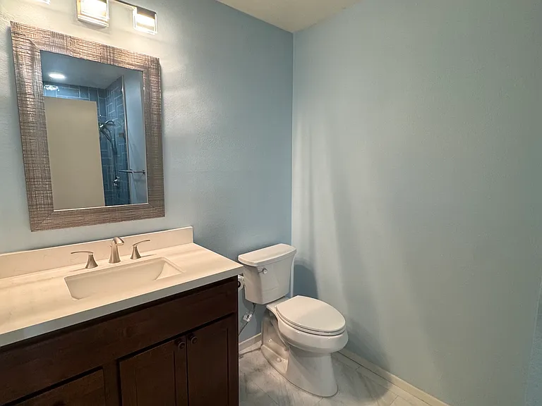 Hall bathroom with updated vanity, newer toilet, updated fixtures