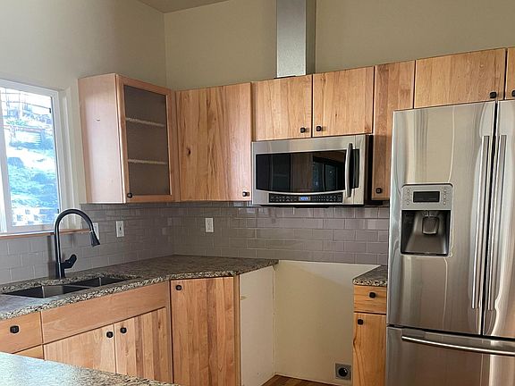 Granite countertops, stainless steel appliances, new stove (not pictured) custom cabinets, large undermount sink with fancy faucet. Bosch dishwasher.