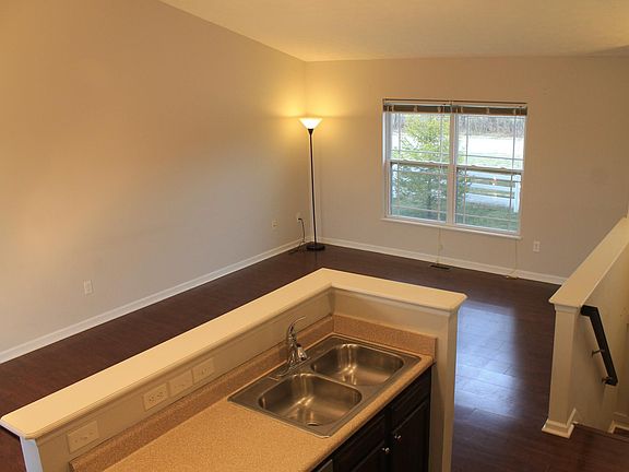Kitchen island (with sink and dishwasher) overlooking living an dining areas