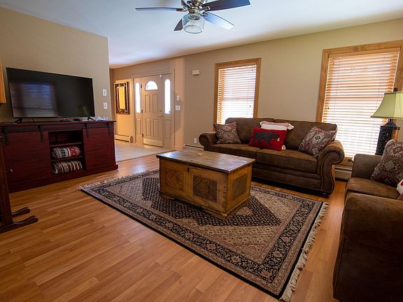 Furnished living room with 50" TV facing front entry