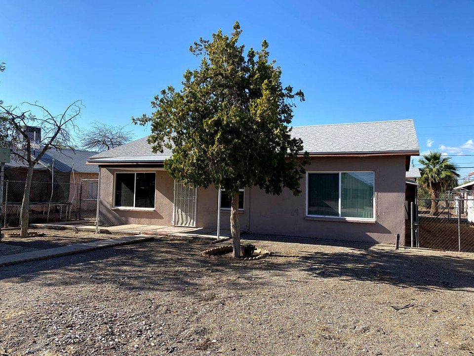 Front of house from corner of fenced yard