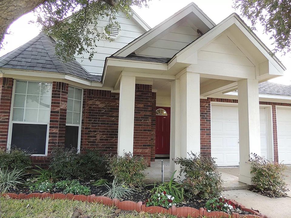 Beautiful entrance with sitting area, landscaping, 2-car attached garage.