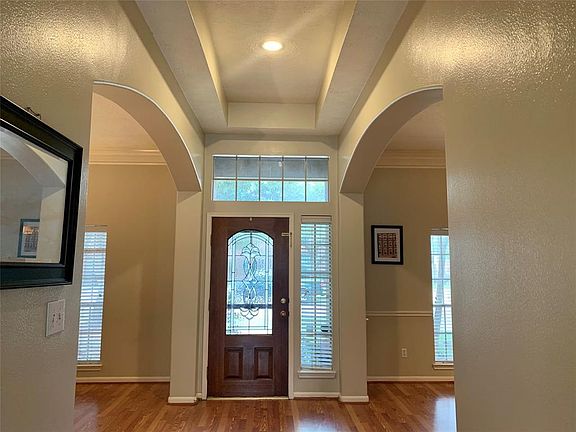 GORGEOUS ENTRY WITH DRAMATIC CEILING AND ARCH ENTRANCES TO THE STUDY AND DINING ROOM
