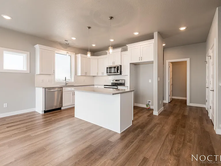 Grand open living space. (Photo of another unit with similar finishes and quality.)