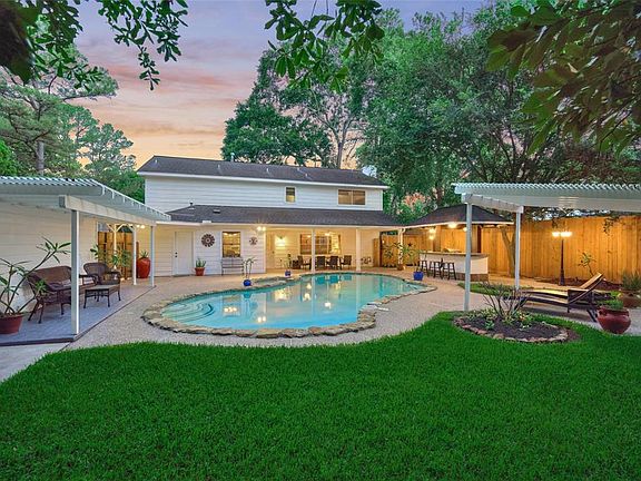 Private backyard oasis pool/spa & outdoor kitchen... surrounded by mature trees this setting invites relaxation and enjoyment.