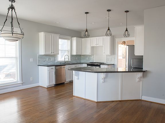 Seamless Flow Between Kitchen, Breakfast Nook, and Living Room. Kitchen cabinets freshly painted!