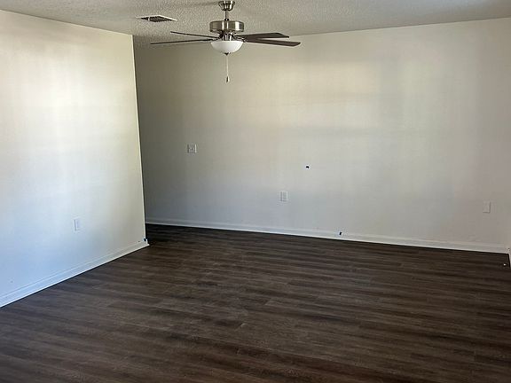 Living room with new ceiling fan and waterproof flooring.