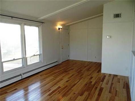 The Great Room With Vaulted Ceilings & Hickory Wood Floors