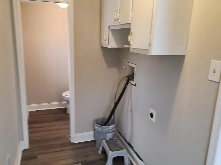 Laundry area off of back entrance with washer/dryer hookup and storage cabinets (w/d incl)