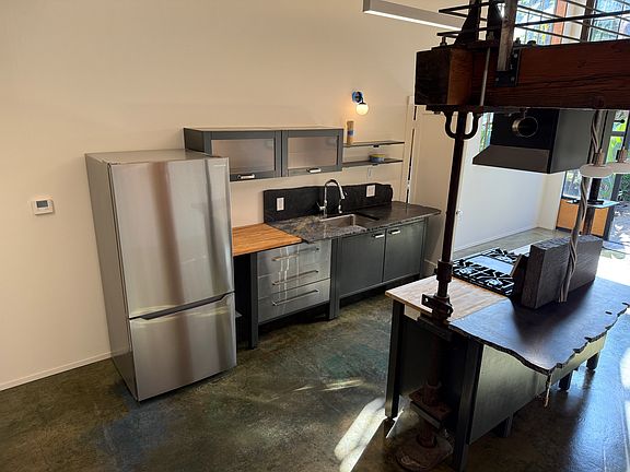 LOOKING AT KITCHEN FROM THE STAIRS GOING UP TO THE LOFT