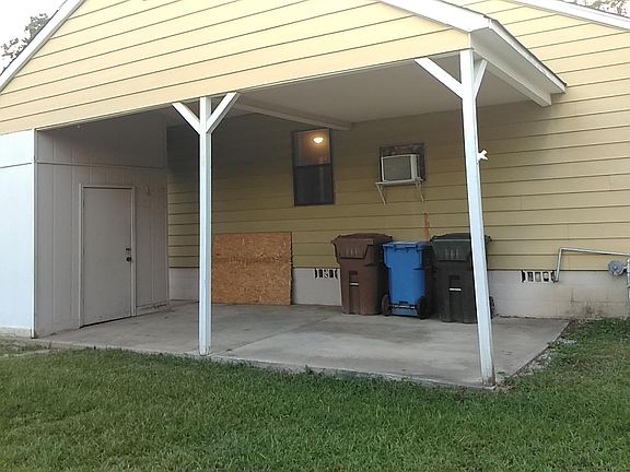 Side of house, carport with storage room