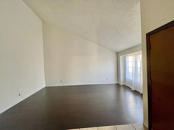 Huge step down living room/bonus room with wood floors and vaulted ceilings