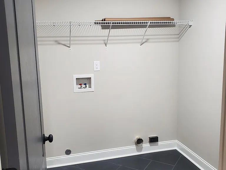 Laundry room with new tile flooring. Washer / dryer hookup