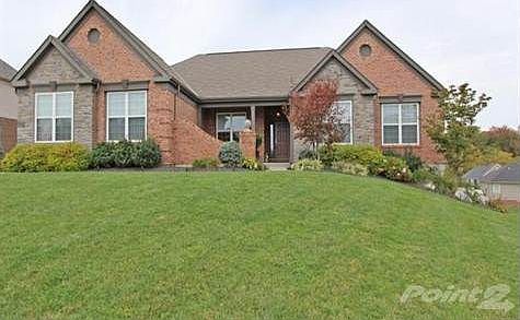 Full brick ranch home with beautiful stone accents and mature well manicured landscaping