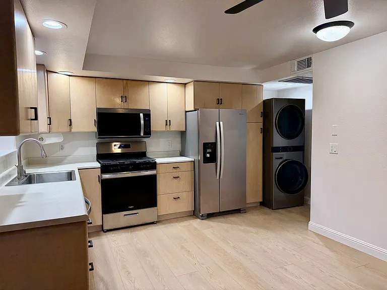 Laundry area between kitchen & bathroom. Laundry tower controls are located in middle of machine & easy to reach.