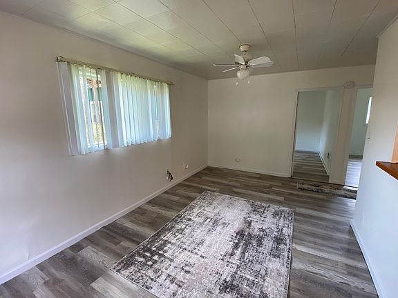 Spacious living room with window, door is entry to bedroom one