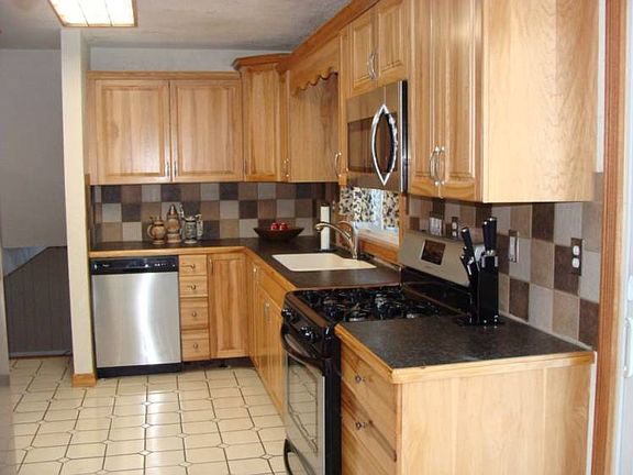 The newer hickory kitchen with stainless steal appliances.